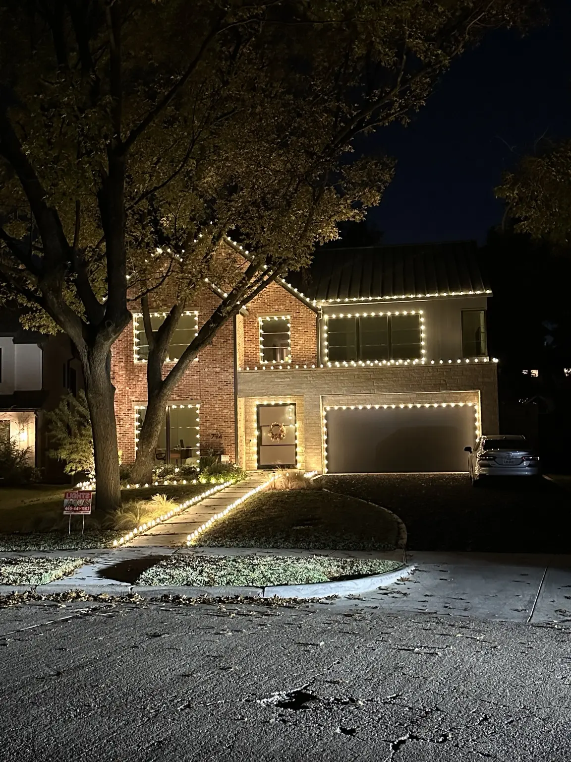 Lakewood Window and Roofline Lighting | Elf's Christmas Lights Lakewood home with warm-white lights outlining roof peaks, windows, garage and entry