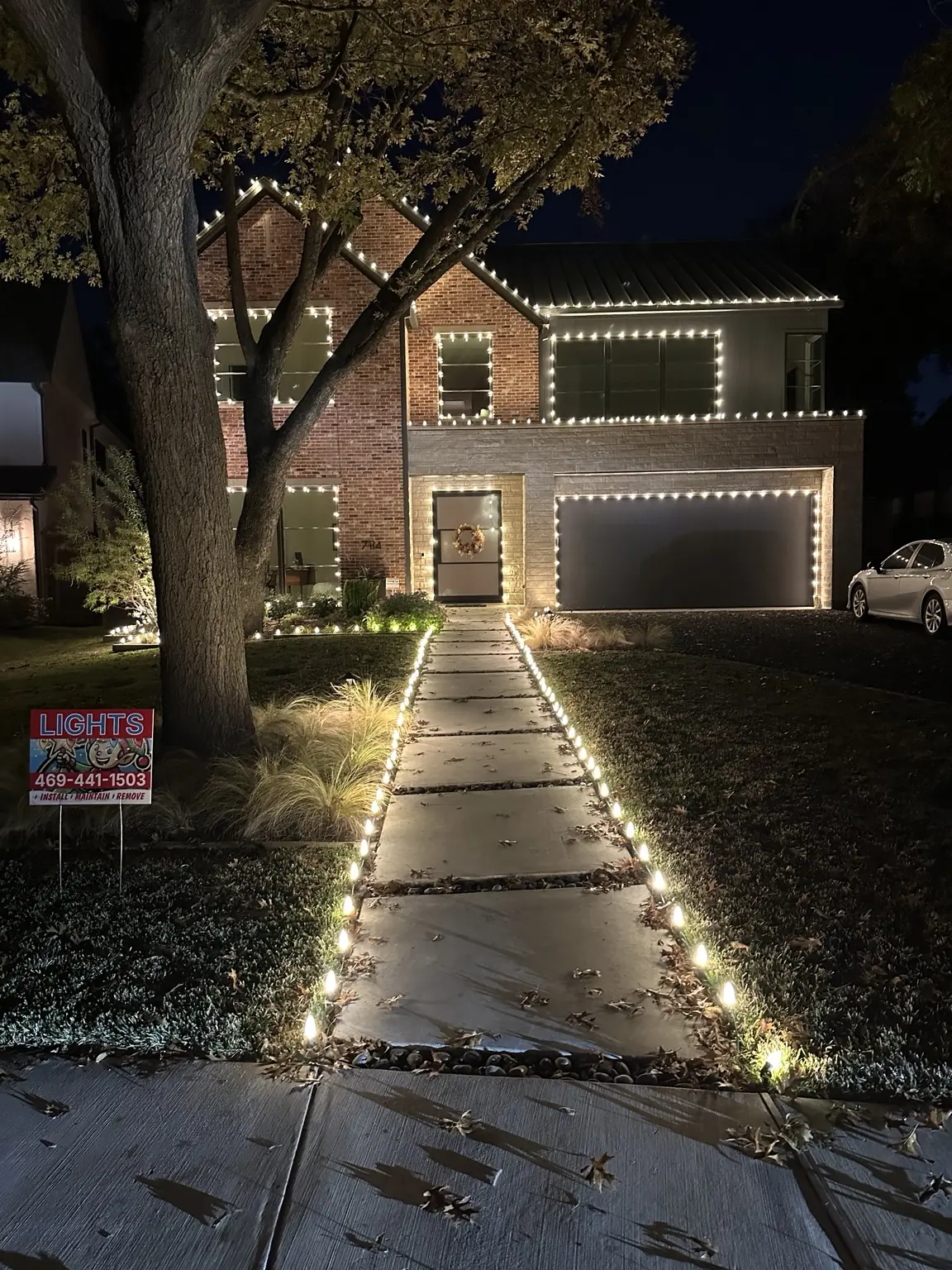 Lakewood Walkway and Roofline Christmas Lights | Elf's Christmas Lights Lakewood brick home with warm-white roofline, window and walkway Christmas lighting