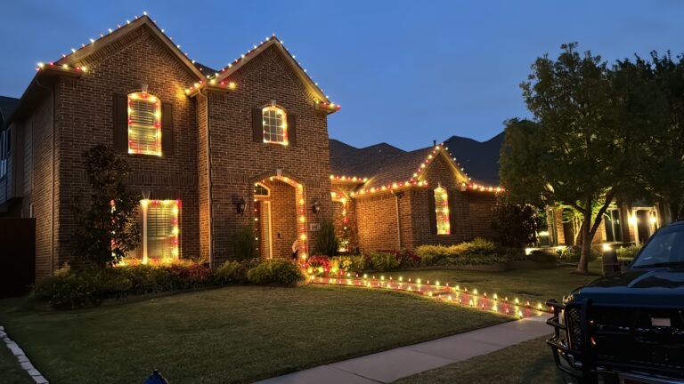 Festive roofline and trees glowing with holiday decorations in Mckinney Eldorado & Heatherwood.
